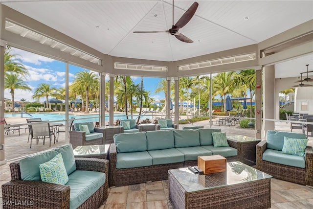 sunroom / solarium with lofted ceiling and ceiling fan