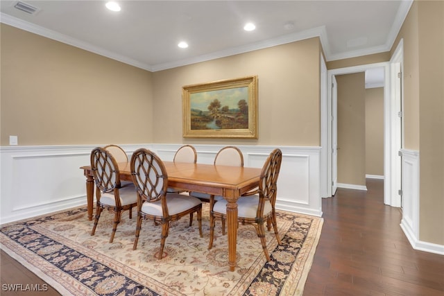 dining room featuring ornamental molding and dark hardwood / wood-style floors