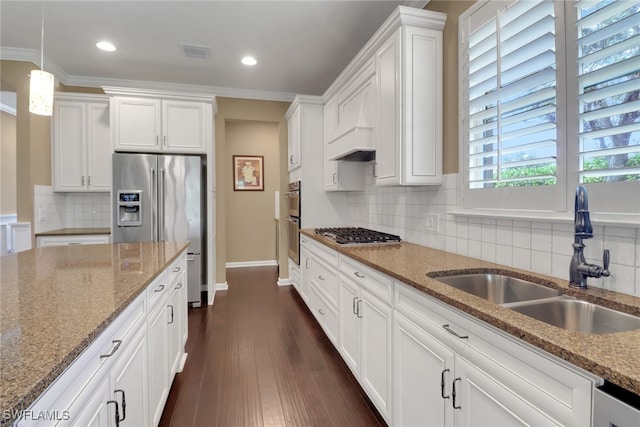 kitchen featuring white cabinets, stainless steel appliances, sink, and light stone countertops