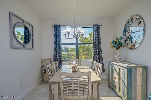 tiled dining room with a notable chandelier