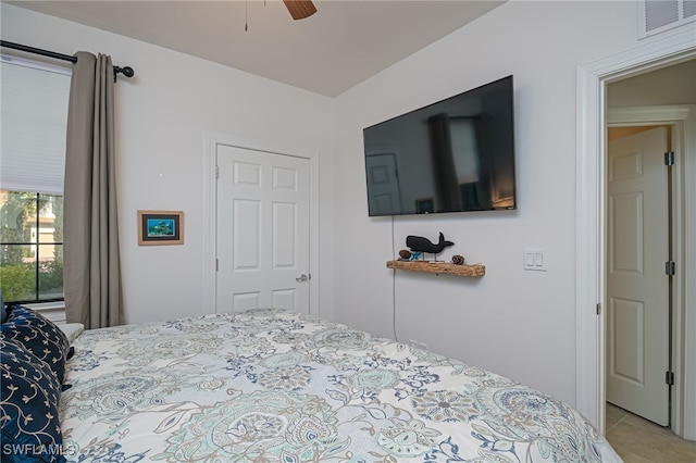 bedroom with ceiling fan and light tile patterned floors