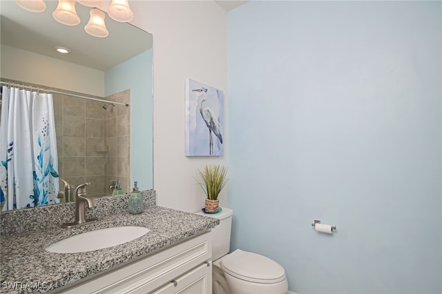 bathroom featuring vanity, a shower with curtain, and toilet