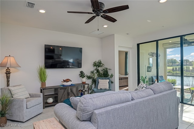 living room with ceiling fan and light tile patterned floors