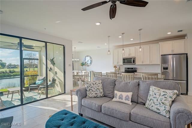 living room featuring light tile patterned floors and ceiling fan