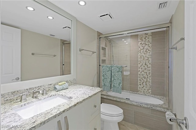 full bathroom with vanity, toilet, and combined bath / shower with glass door