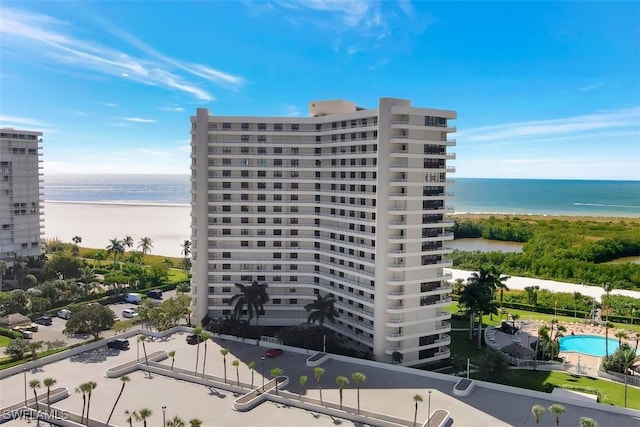 view of property with a water view and a view of the beach