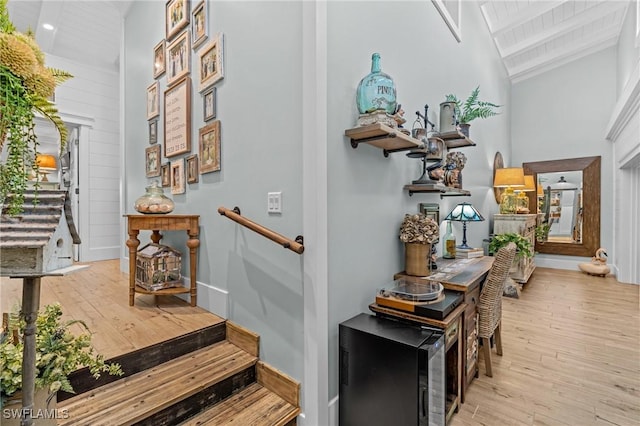 interior space with wooden ceiling, baseboards, high vaulted ceiling, hardwood / wood-style flooring, and beam ceiling