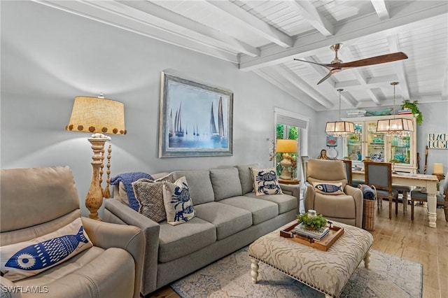 living area with light wood-style flooring, lofted ceiling with beams, and a ceiling fan