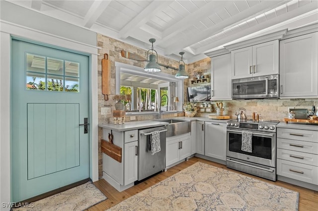 840 Myrtle Ter, Naples, FL 34103 - kitchen featuring appliances with stainless steel finishes, backsplash, healthy amount of natural light, light countertops, and beamed ceiling