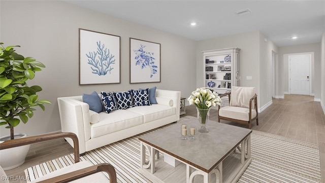 living room featuring wood tiled floor, visible vents, baseboards, and recessed lighting