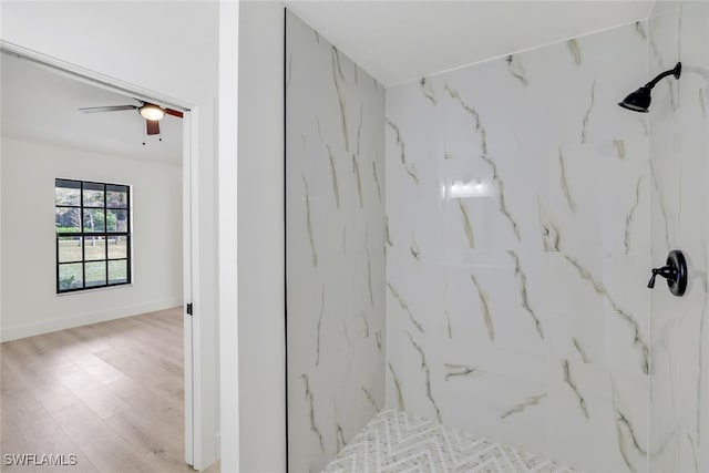 interior space featuring wood-type flooring and a tile shower