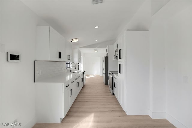 hallway with sink and light hardwood / wood-style floors