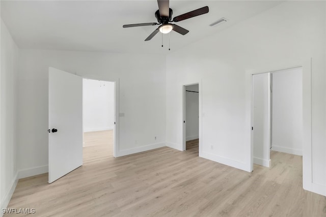 unfurnished bedroom with vaulted ceiling, ceiling fan, and light hardwood / wood-style floors