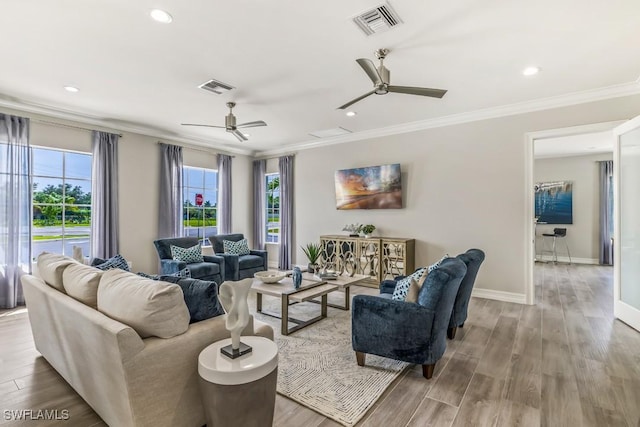 living room featuring crown molding, light hardwood / wood-style flooring, and ceiling fan