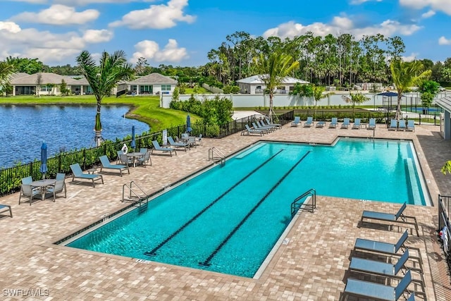 view of swimming pool with a water view and a patio