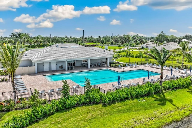 view of swimming pool with a patio and a lawn