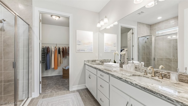 bathroom with walk in shower and vanity