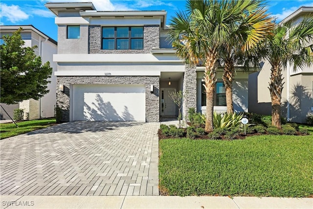 view of front facade featuring a front yard, stucco siding, a garage, stone siding, and decorative driveway