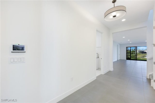 corridor featuring recessed lighting and baseboards