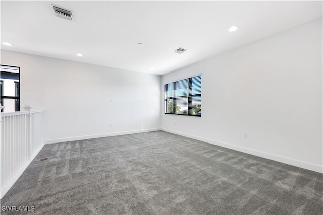 empty room featuring visible vents, recessed lighting, baseboards, and carpet floors