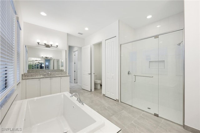 bathroom with visible vents, a shower stall, toilet, a bath, and vanity