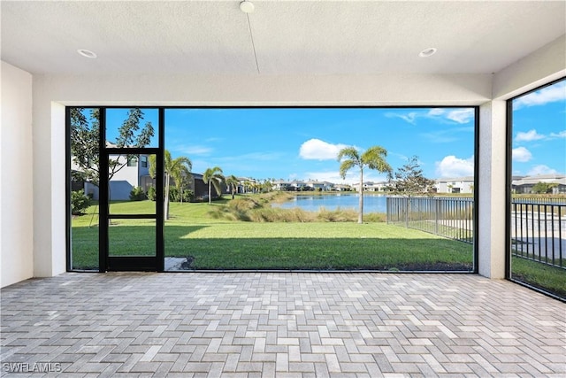 unfurnished sunroom with a water view