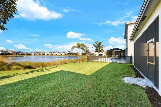 view of yard with fence and a water view