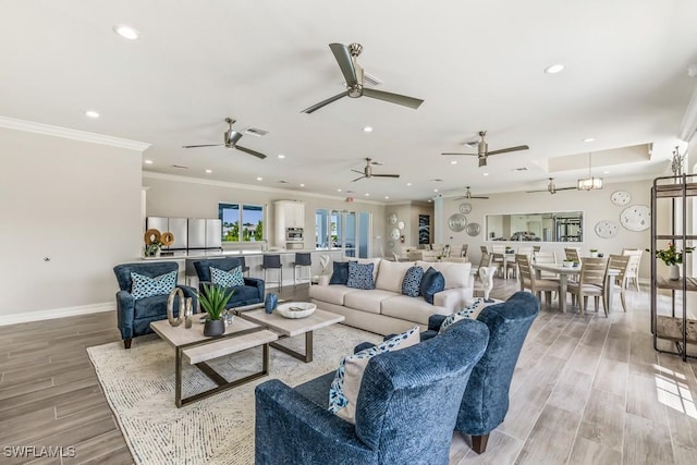 living room with ornamental molding and light hardwood / wood-style flooring