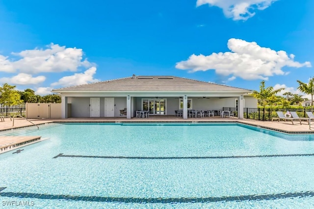 view of swimming pool with ceiling fan and a patio area