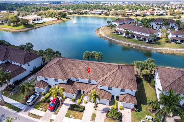 birds eye view of property featuring a water view and a residential view