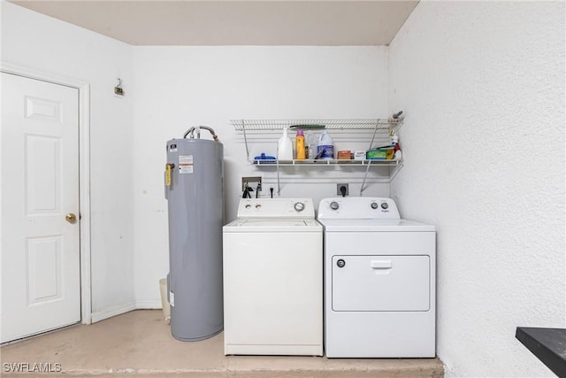 clothes washing area featuring laundry area, water heater, and washing machine and clothes dryer