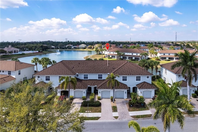 drone / aerial view with a water view and a residential view