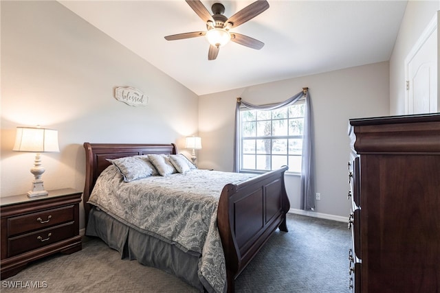 bedroom featuring vaulted ceiling, dark carpet, baseboards, and ceiling fan