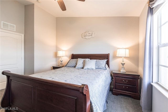 bedroom with a ceiling fan, visible vents, and carpet flooring