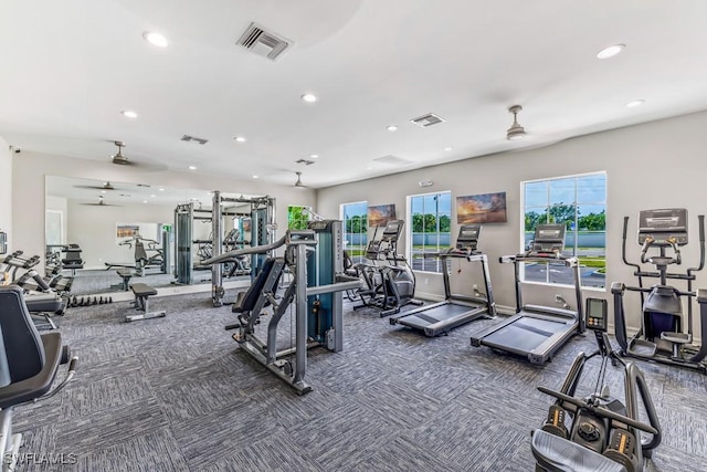 exercise room featuring ceiling fan and dark colored carpet