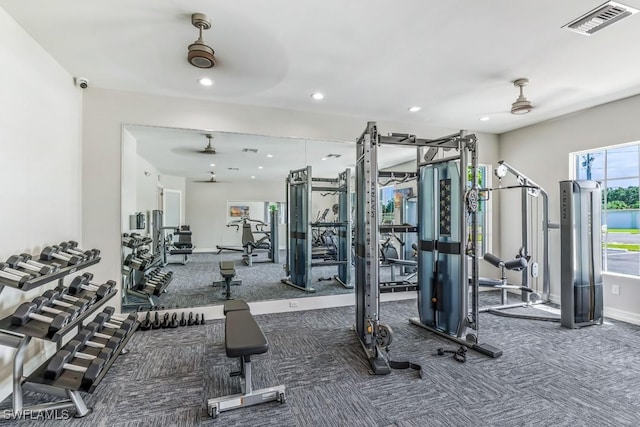 exercise room featuring dark carpet and ceiling fan