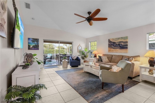 tiled living room with ceiling fan, vaulted ceiling, and a healthy amount of sunlight