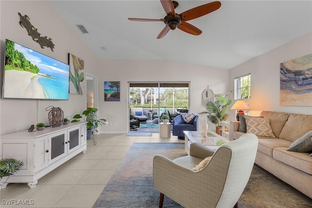 living room featuring lofted ceiling, light tile patterned flooring, and ceiling fan