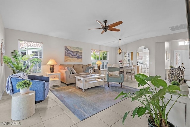 tiled living room featuring lofted ceiling and ceiling fan