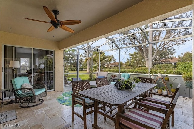 sunroom featuring ceiling fan