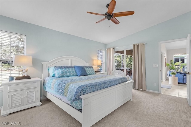 bedroom with light carpet, multiple windows, lofted ceiling, and access to exterior