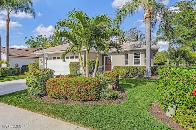 ranch-style home with a front yard and a garage