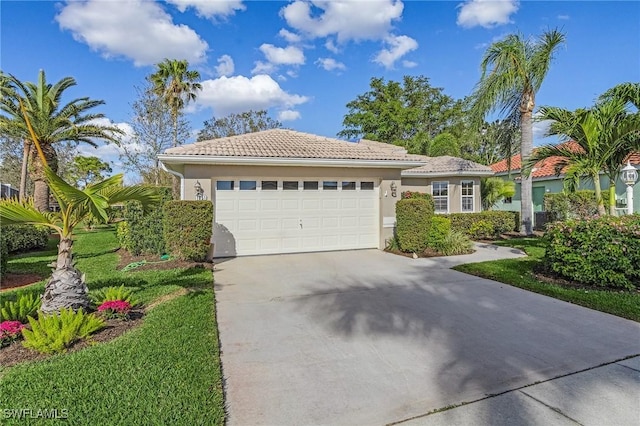 view of front of house with a front yard and a garage