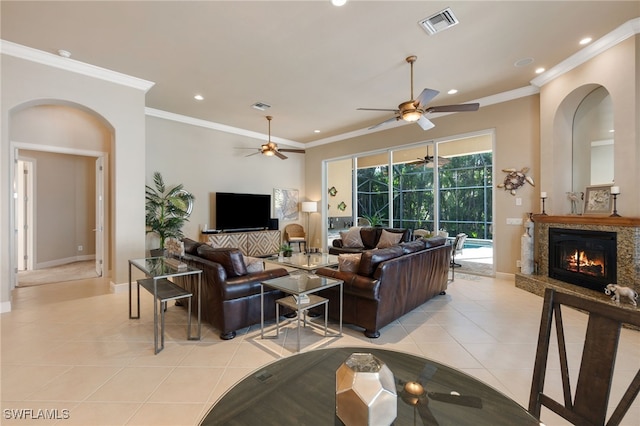 living area with a ceiling fan, light tile patterned flooring, crown molding, and visible vents