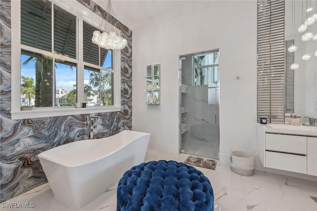 full bath with a notable chandelier, vanity, a freestanding bath, marble finish floor, and a marble finish shower