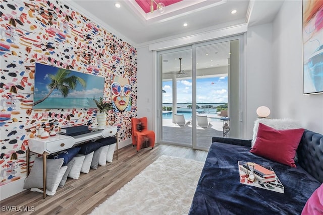 bedroom with crown molding, recessed lighting, wood finished floors, and access to exterior