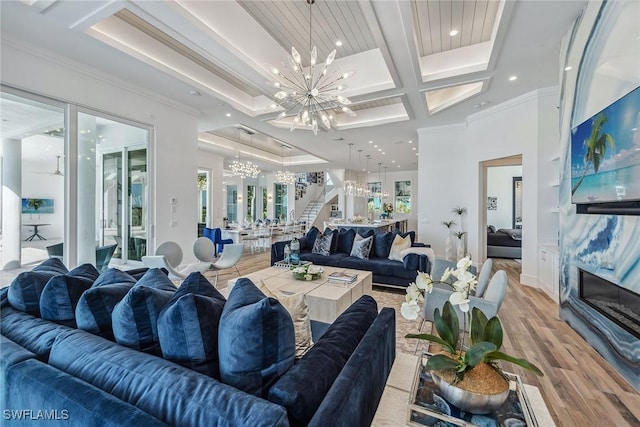 living area featuring light wood finished floors, coffered ceiling, beamed ceiling, stairs, and a notable chandelier