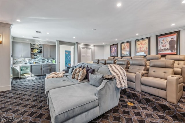 home theater room featuring visible vents, ornamental molding, dark carpet, bar area, and recessed lighting