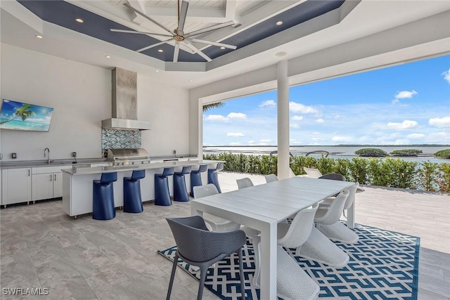 dining space with recessed lighting, a water view, and ceiling fan