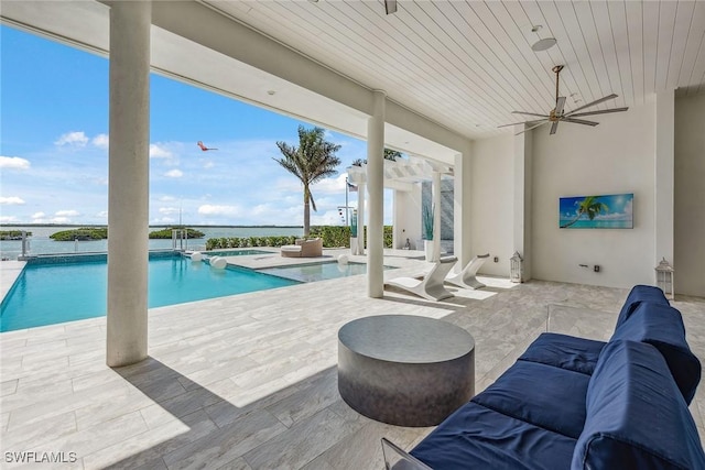 pool with ceiling fan, a patio, and an in ground hot tub